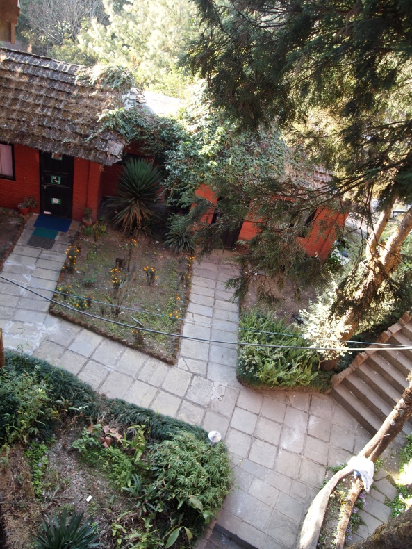 a view from the balcony of the hotel to the gardens below